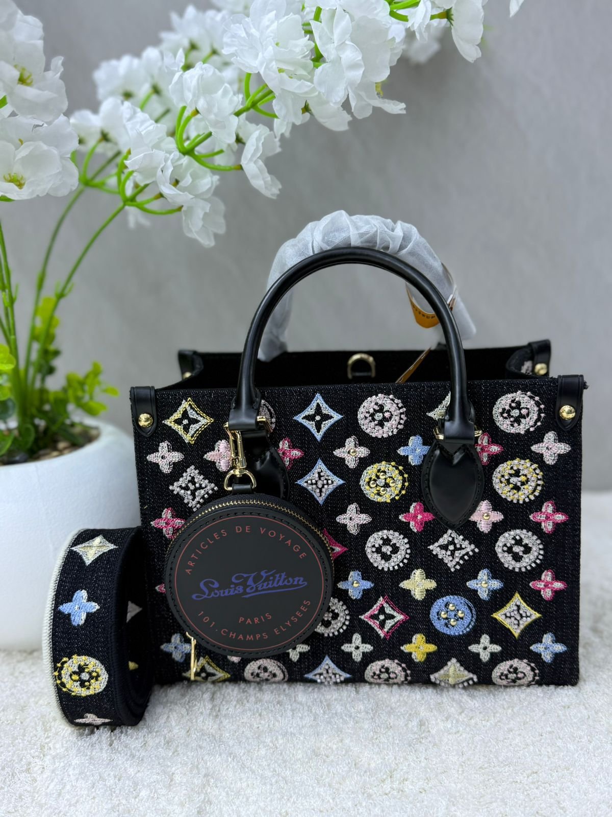 Louis Vuitton OnTheGo GM tote bag is crafted from black and beige bicolor monogram empreinte leather.