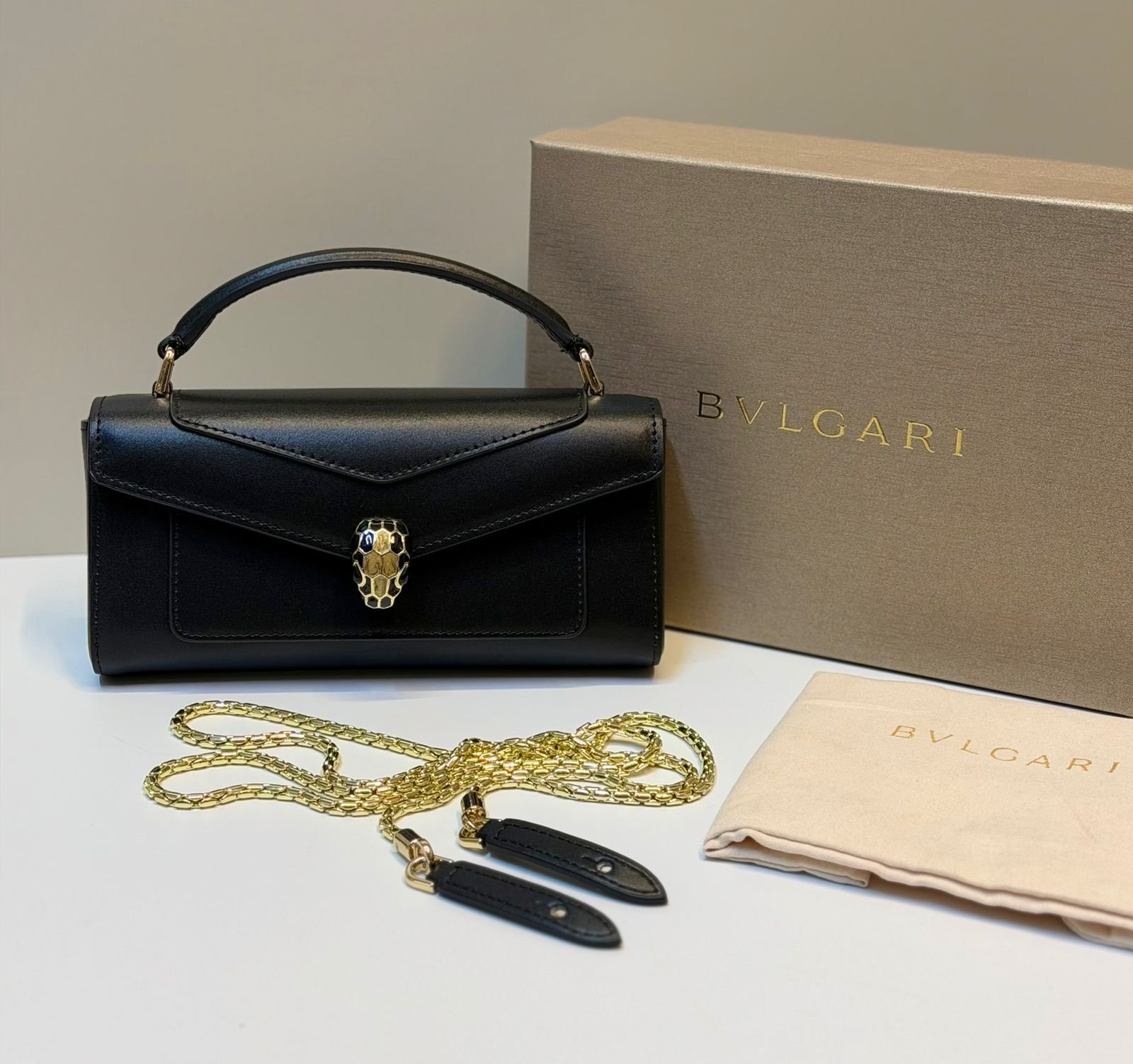 Bvlgari Serpenti Forever leather phone pouch, featuring a detachable chain strap and iconic snakehead closure